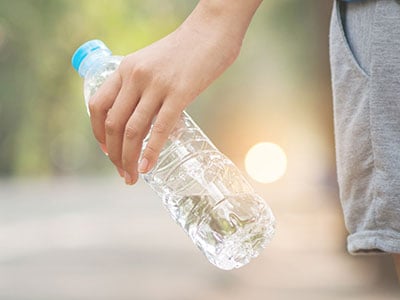 picture of person holding bottle of water
